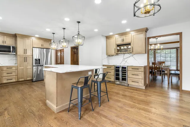 a large kitchen with a table and chairs