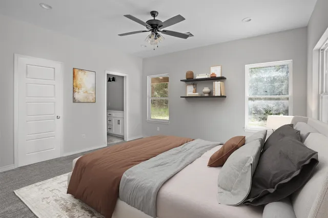 a bedroom with a bed and a window