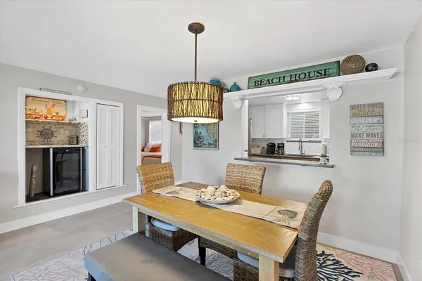 a living room with dining table and a wooden floor