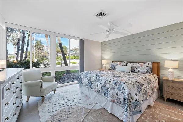 a bedroom with a large bed and a window