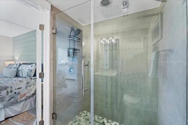 a bathroom with a shower and a sink