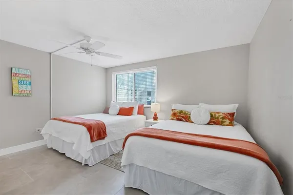 a bedroom with two beds and painted walls