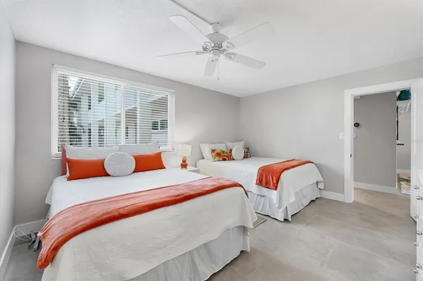 a bedroom with two beds and painted walls