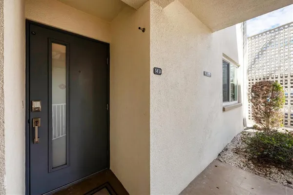 a view of entryway with a small yard