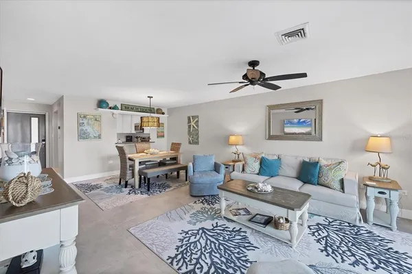 a living room with furniture a rug and a chandelier