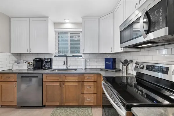 a kitchen with stainless steel appliances granite countertop a stove and a sink