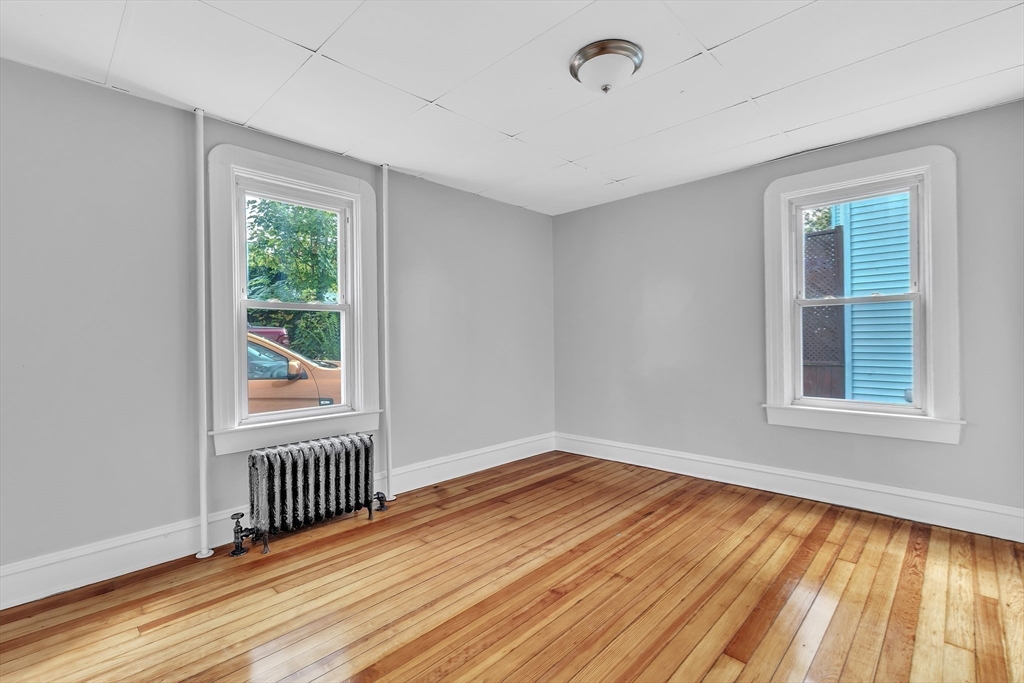 256 Whipple Street Fall River, MA 02721 - Photo 13 of 42 wooden floor in an empty room with a window