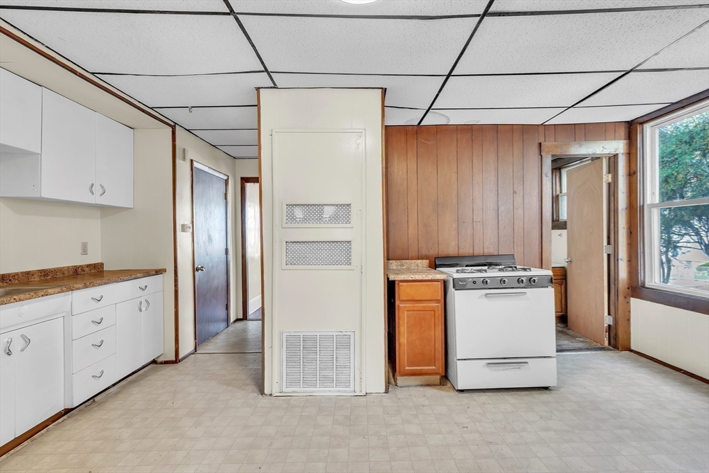 256 Whipple Street Fall River, MA 02721 - Photo 32 of 42 a kitchen with stainless steel appliances granite countertop a refrigerator and a stove