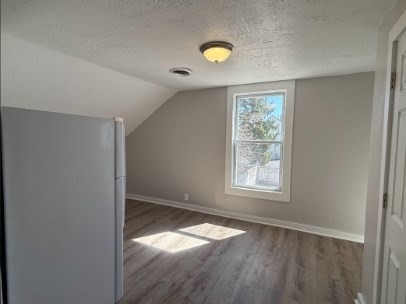256 Whipple Street Fall River, MA 02721 - Photo 40 of 42 an empty room with wooden floor and windows