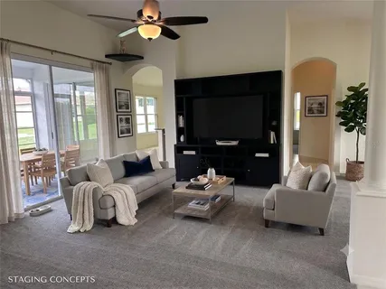 a living room with furniture and a large window