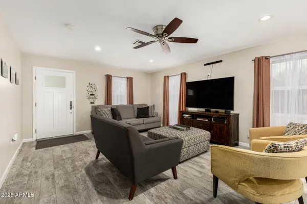 a living room with furniture and a flat screen tv