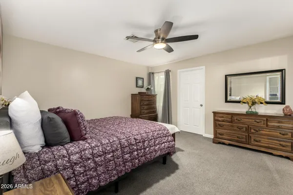 a bedroom with a bed and dresser