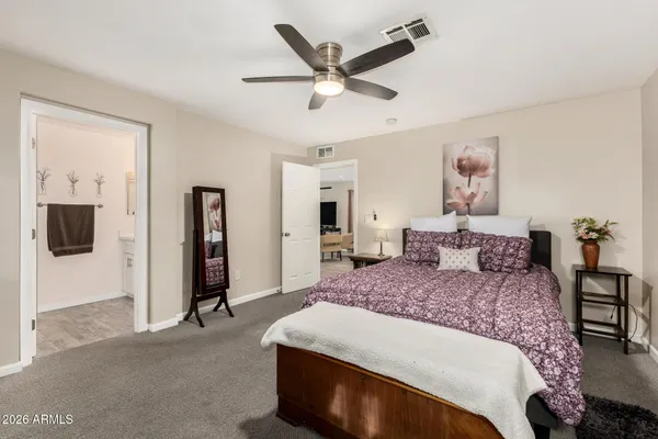 a bedroom with a bed and a chandelier