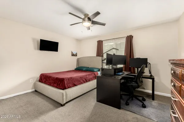 a bedroom with a bed and a desk