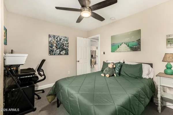 a bedroom with a bed and a desk
