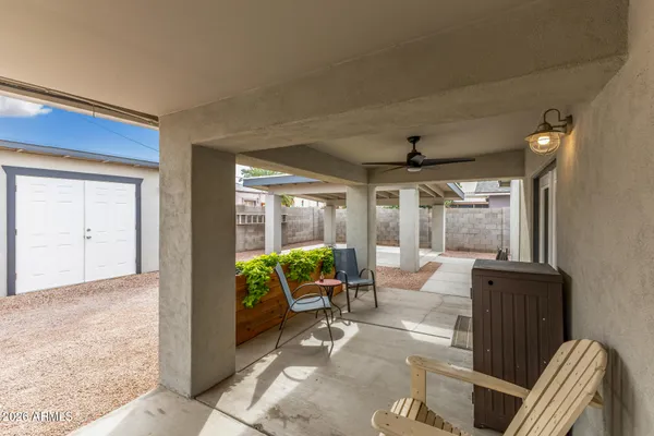 a living room with furniture and large windows