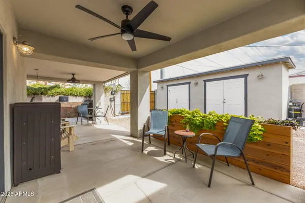 a balcony with furniture and a ceiling fan