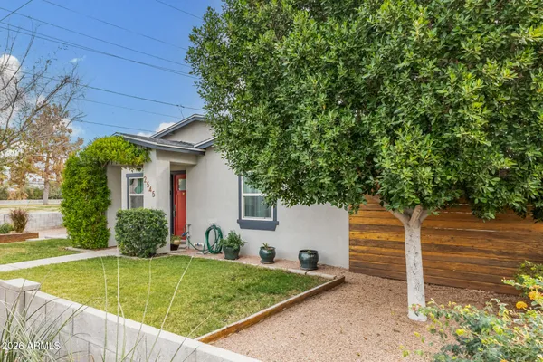 a view of a house with pool and a yard