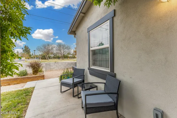a view of a house with backyard and sitting area