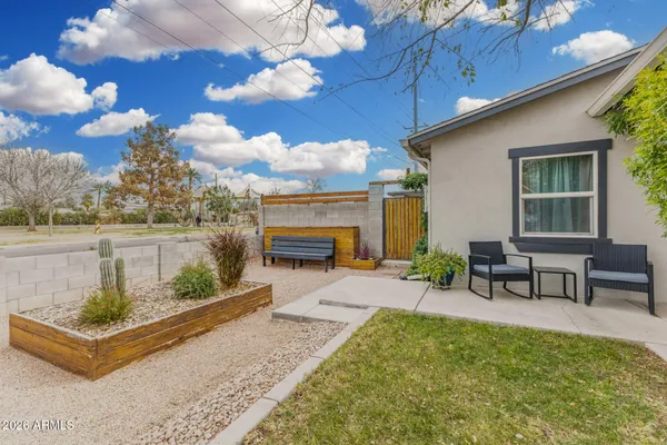 a view of a patio with table and chairs with wooden floor and fence