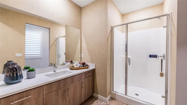 a bathroom with a double vanity sink and a mirror