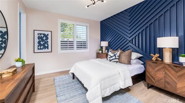 a bedroom with bed and a night stand