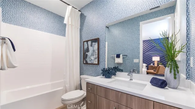 a bathroom with a sink a toilet a tub and shower