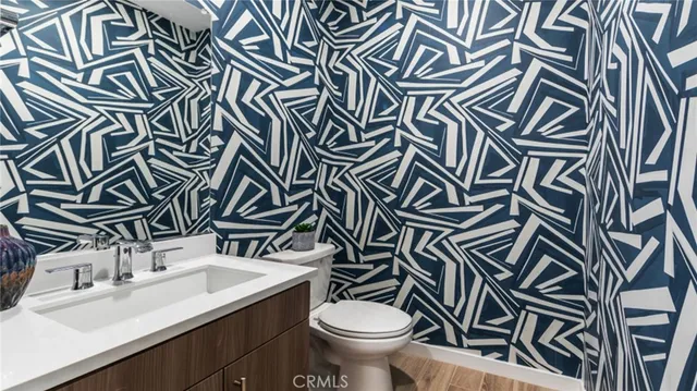 a bathroom with a sink a toilet and mirror