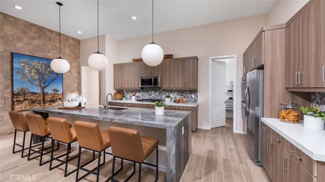 a large kitchen with a table and chairs