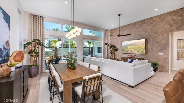 a living room with furniture a chandelier and a large window