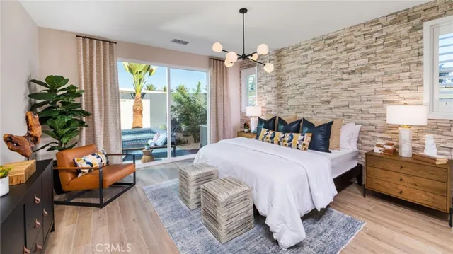 a spacious bedroom with a bed a couch and a potted plant