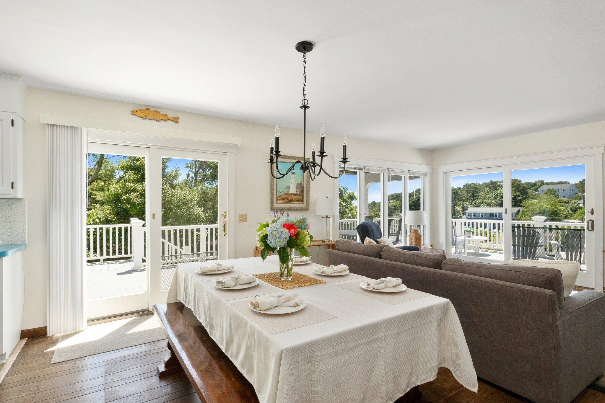 4 Portview Road Chatham, MA 02659 - Photo 21 of 69 a view of a dining room with furniture wooden floor and a chandelier