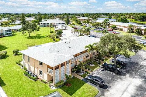 an aerial view of a house with swimming pool garden and lake view