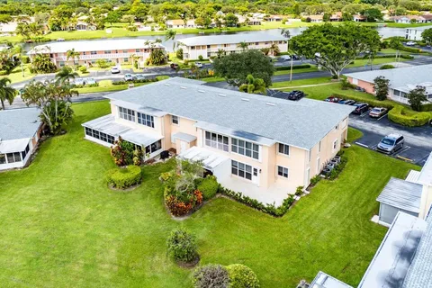 an aerial view of residential houses with outdoor space and lake view