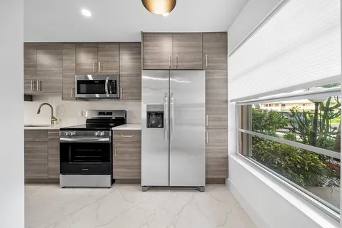 a kitchen with stainless steel appliances a refrigerator and a stove