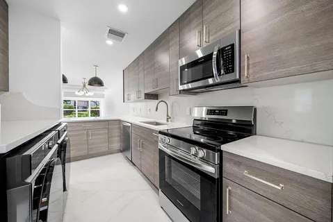 a kitchen with a cabinets and chandelier