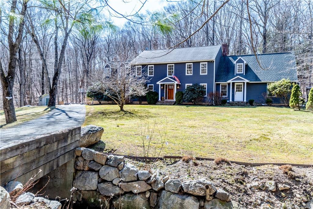 Welcome home to 379 Georgetown Road in Weston. Set back off the road, you cross a small stream via a quaint bridge to get there.