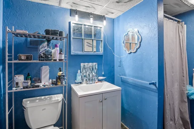 a room with a wooden floor and cabinets