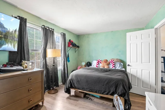 a bedroom with a bed and a dresser