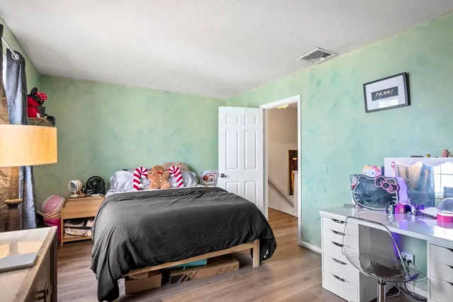 a bedroom with a bed and a desk