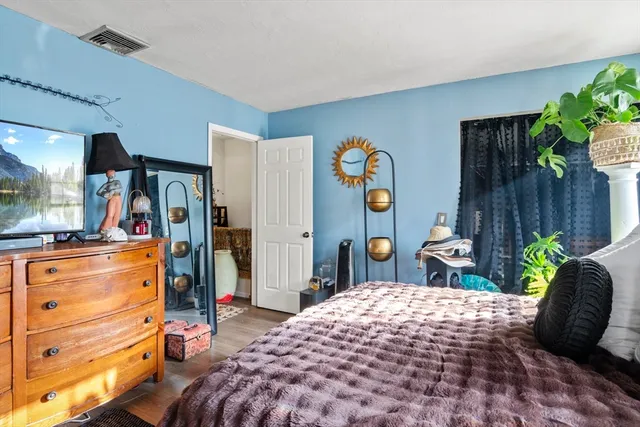 a bedroom with a bed and a window