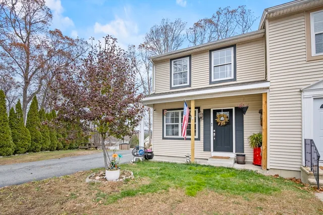 a front view of a house with a yard and tree s