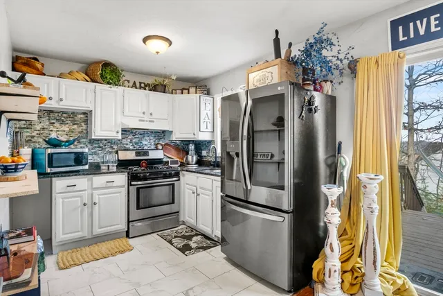 a kitchen with stainless steel appliances a refrigerator sink and cabinets