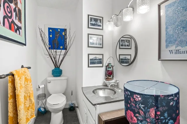 a bathroom with a toilet a sink and a mirror