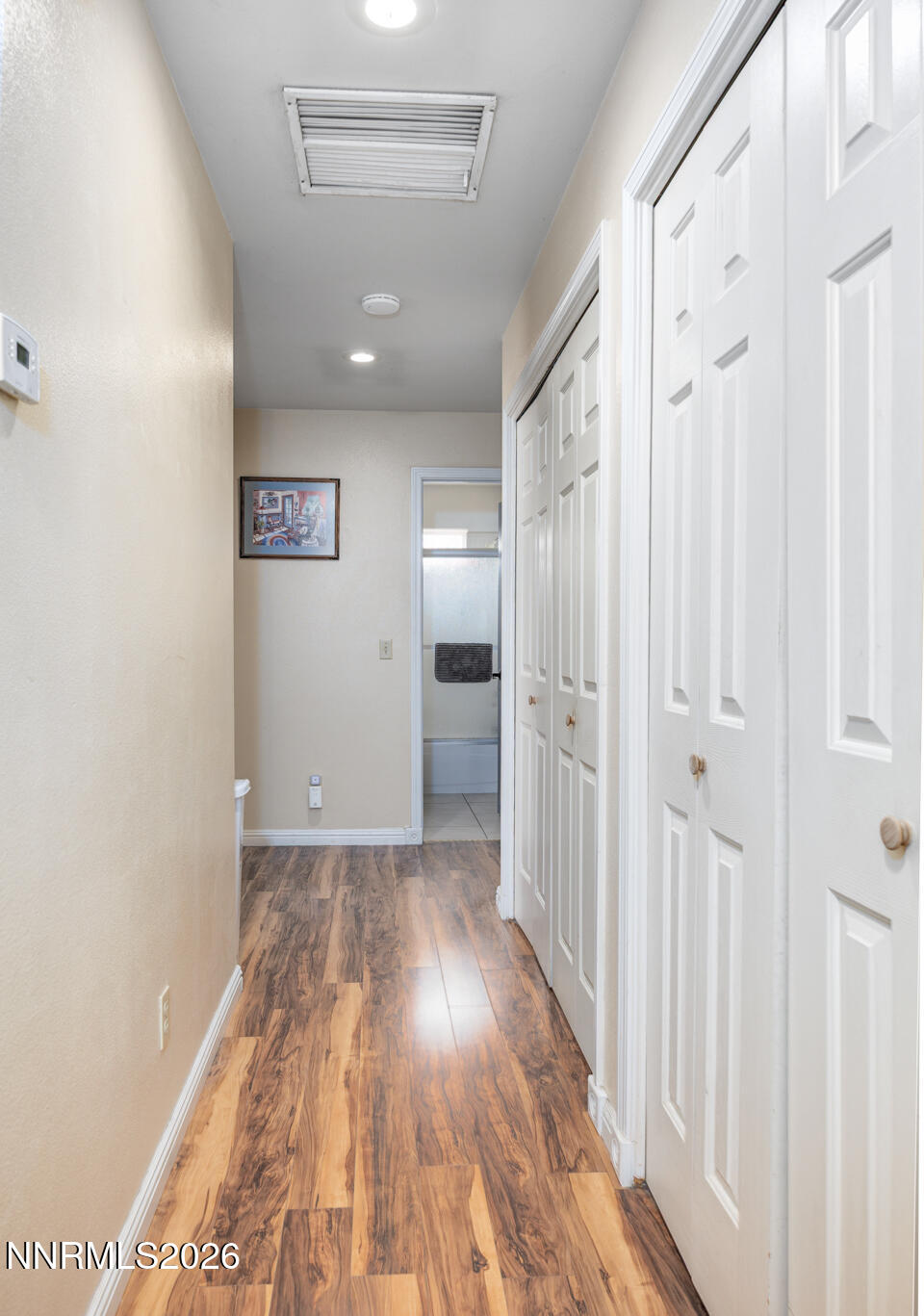 4033 Cimarron Road Fallon, NV 89406 - Photo 11 of 31 a view of a hallway with wooden floor