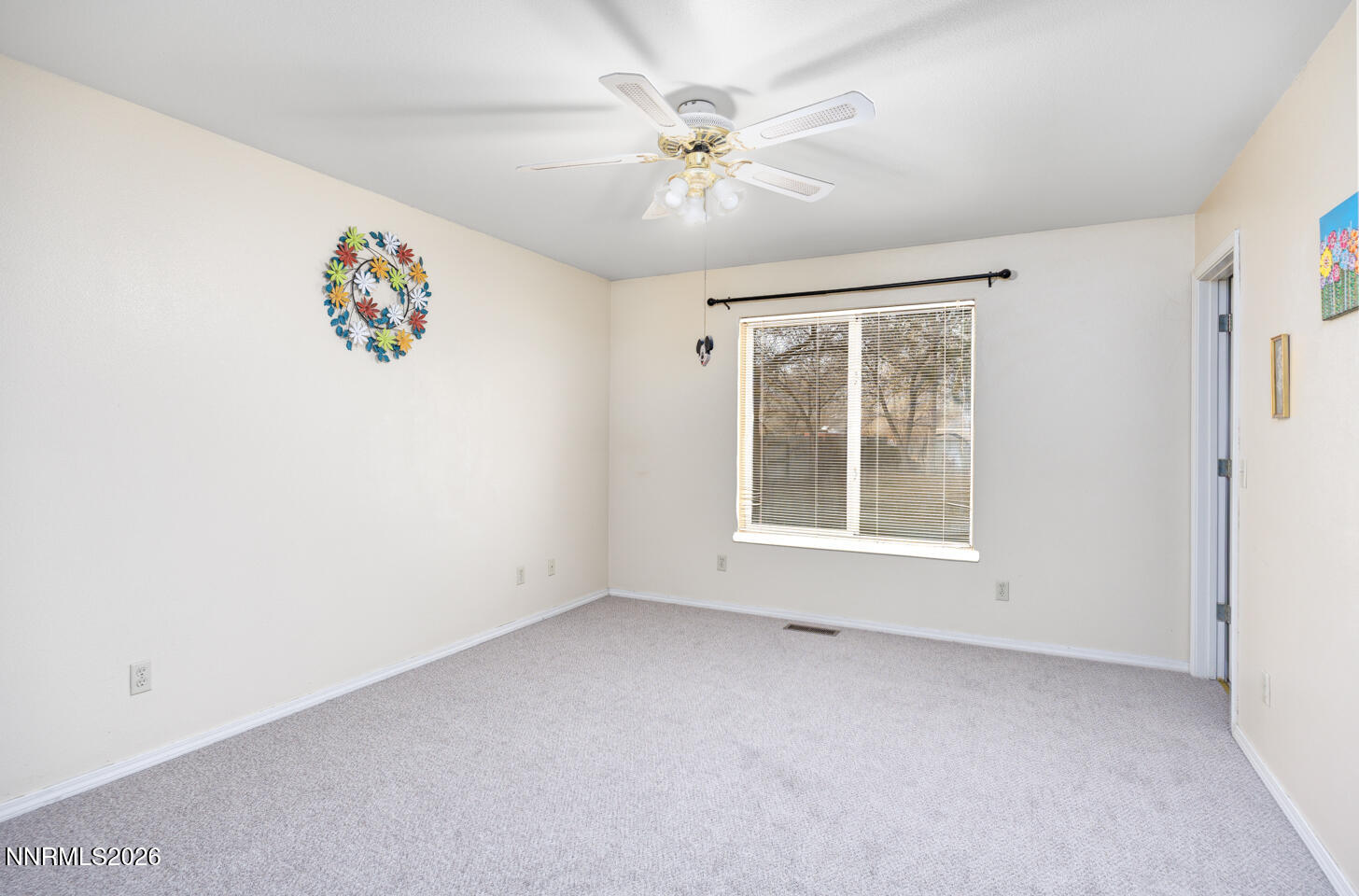 4033 Cimarron Road Fallon, NV 89406 - Photo 16 of 31 an empty room with a window and a ceiling fan