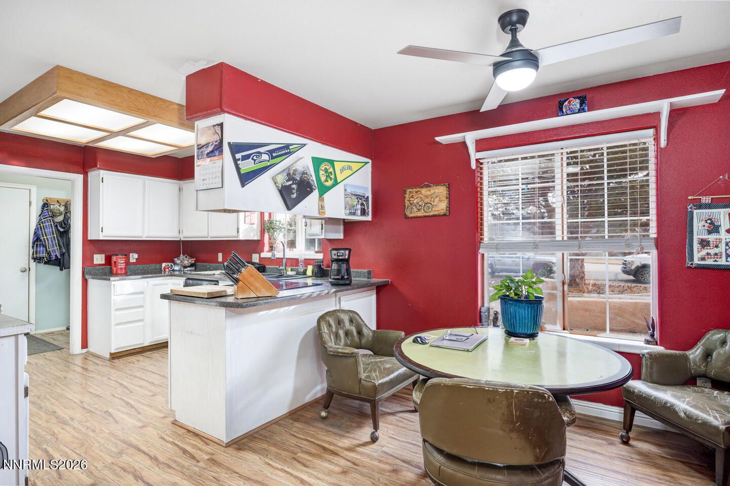 4033 Cimarron Road Fallon, NV 89406 - Photo 7 of 31 a kitchen with a stove a refrigerator and a dining table with wooden floor