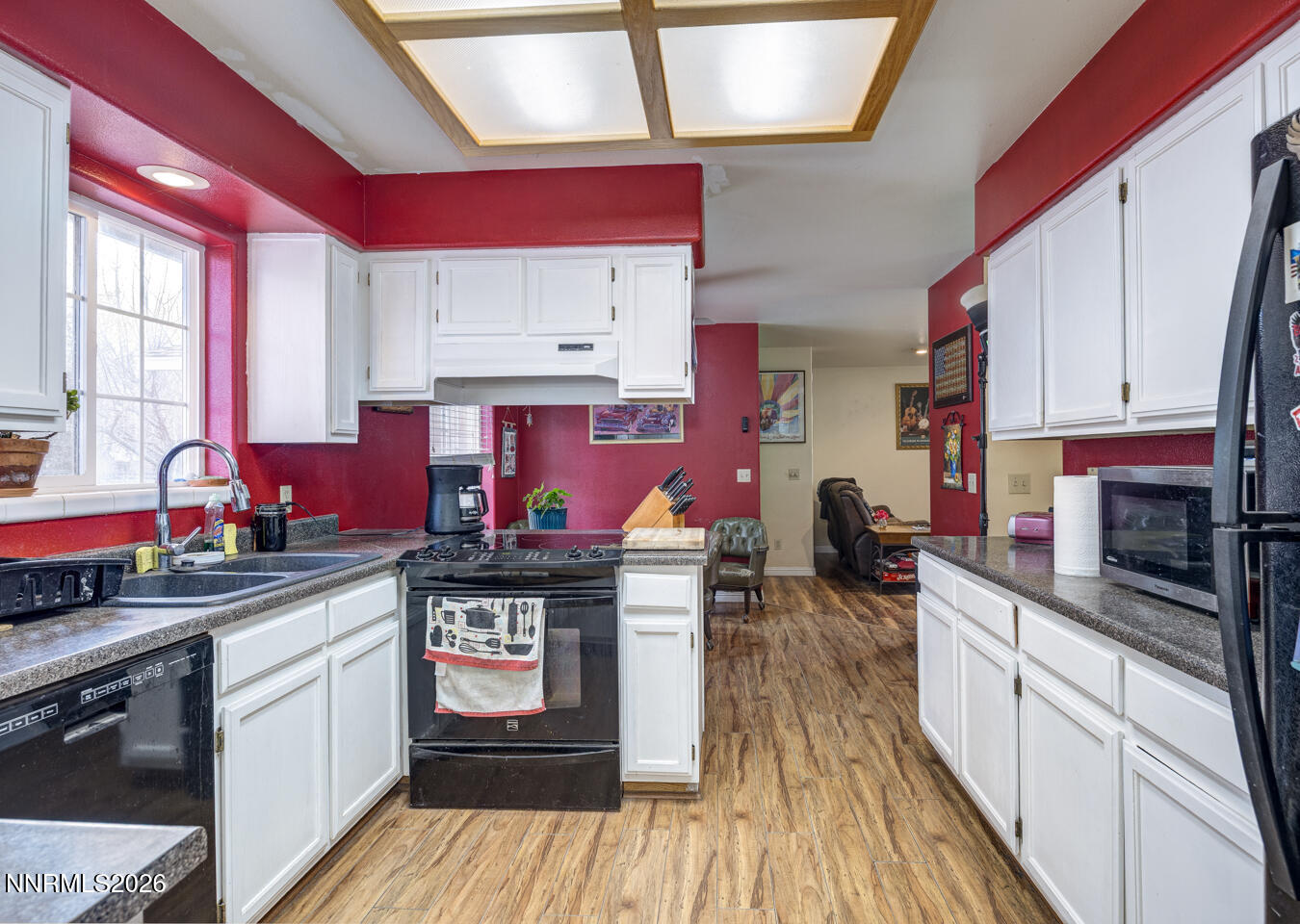4033 Cimarron Road Fallon, NV 89406 - Photo 9 of 31 a kitchen with stainless steel appliances granite countertop a stove a sink dishwasher and cabinets with wooden floor