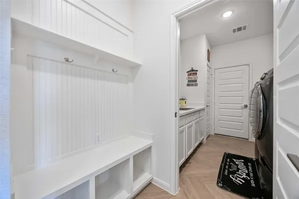 a bedroom with a bed and a flat tv screen on the dresser
