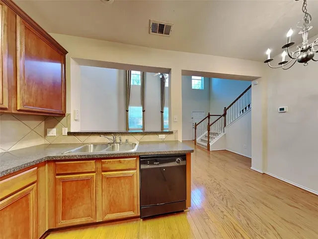 a kitchen with wooden floors and a sink